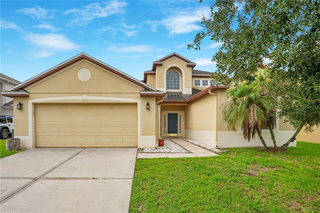 Front elevation of 3571 Maple Ridge Loop with two-car garage and covered entry.