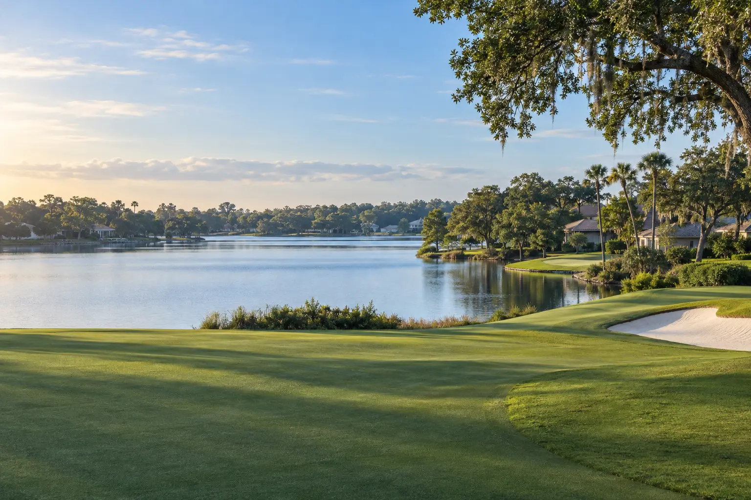 Illustrative Bay Hill, Florida landscape with a green golf fairway, calm lake, mature trees and homes nestled along the distant shoreline.