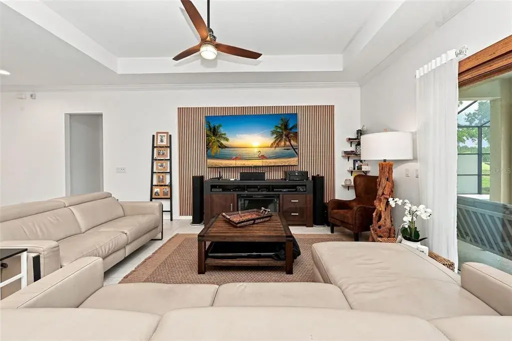 Spacious living room with 85-inch television and surround sound system.