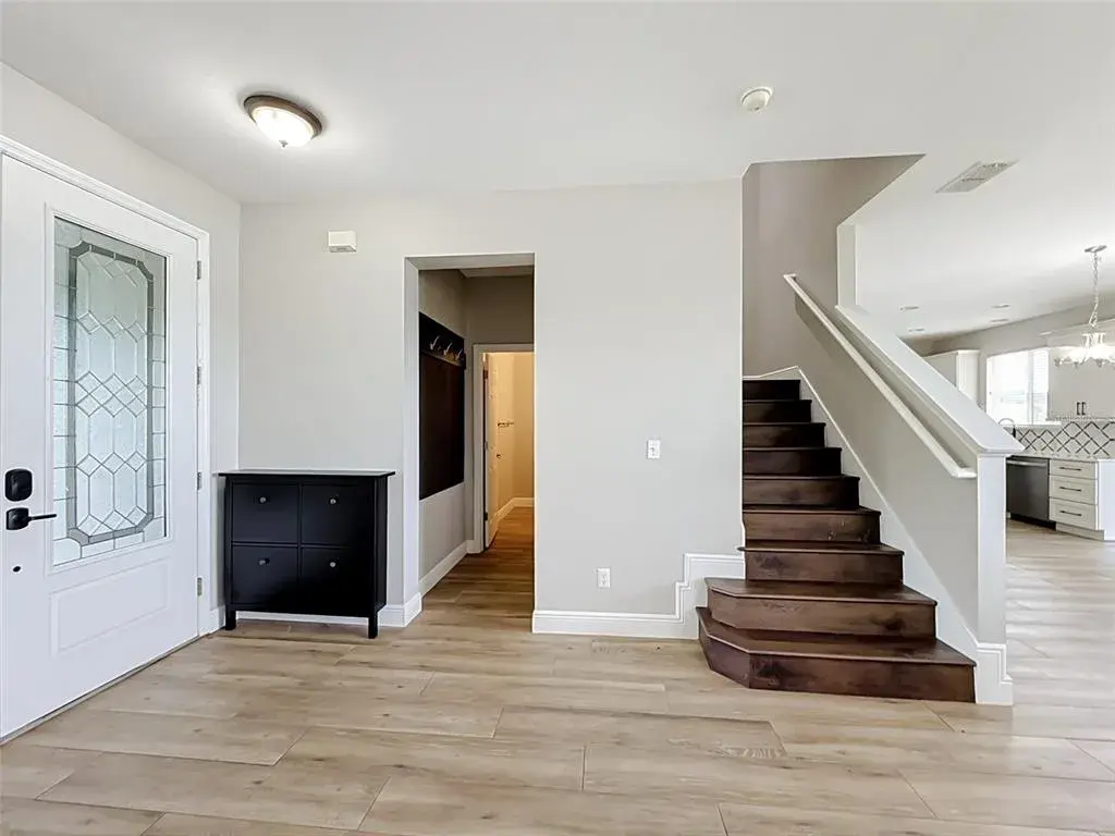 Foyer with hardwood staircase to the second floor