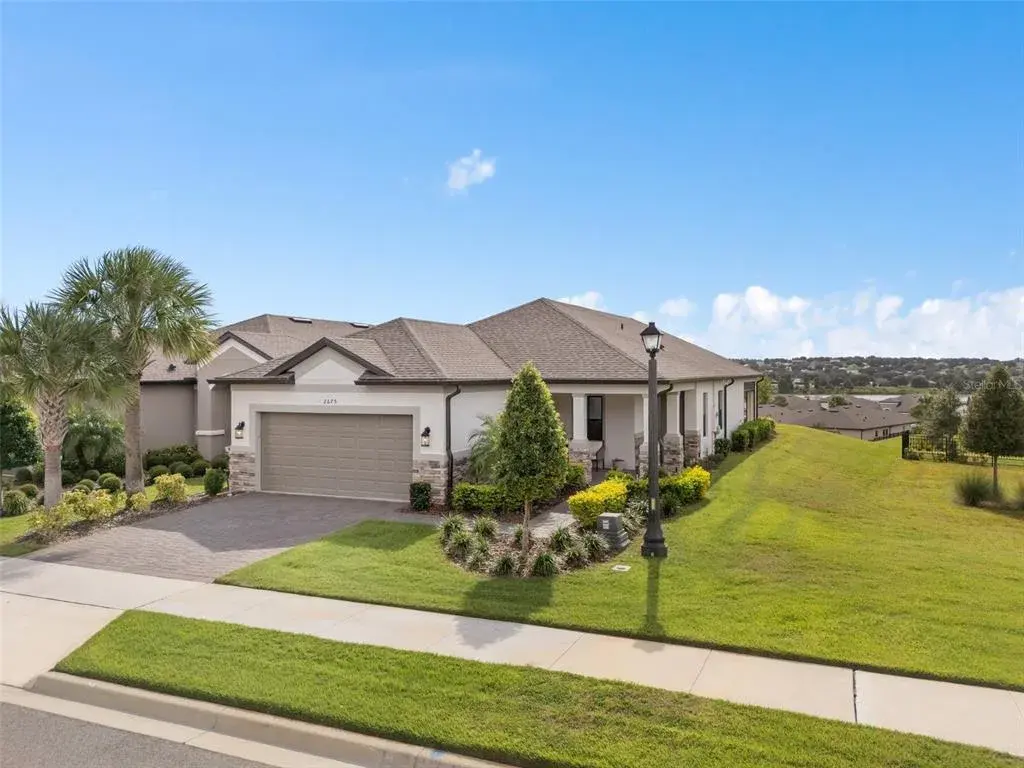 Front View offering an Upgraded Elevation with Under Roof porch, Stone Accents and beautiful curb appeal
