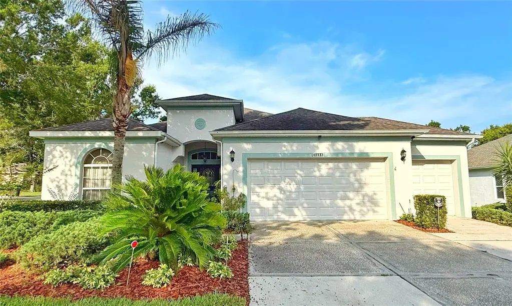 Front exterior w gutters, corner lot, flat, golf cart garage, front entry with glass storm door