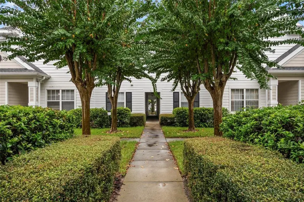 Well manicured mature landscaping greets you as you approach building 14, unit 208