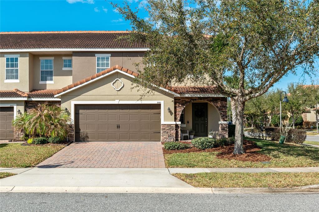 Welcoming front elevation with charming curb appeal and a spacious two-car garage