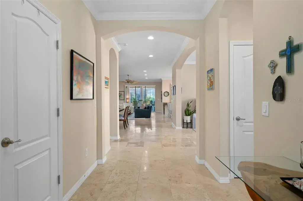 Upon entry to the Foyer is a beautiful see through floor plan with Travertine Flooring