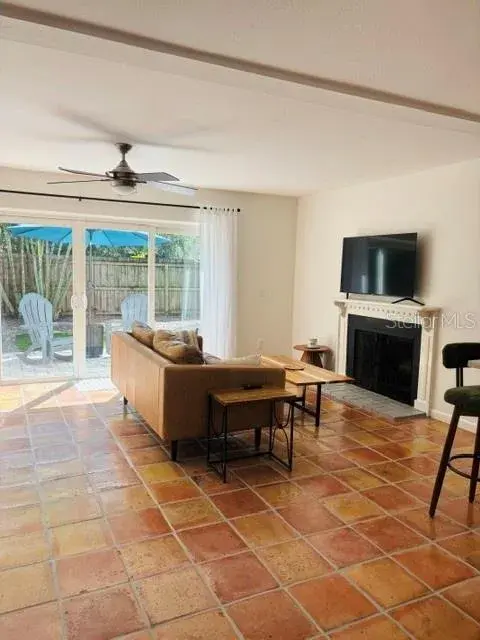 Warm & welcoming living area with wood burning fireplace