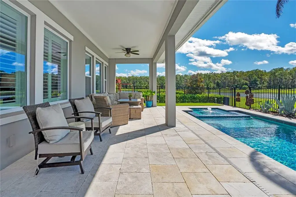 Extended covered lanai overlooking the pool and water and conservation view. Pre wired for surround sound.