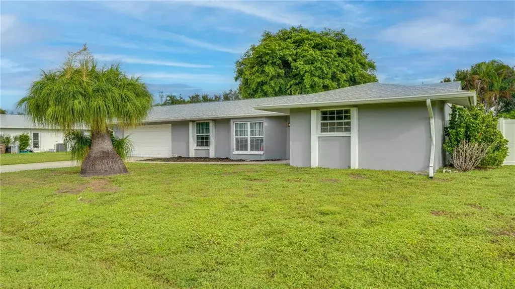 Single-story residence featuring a neutral exterior, white trim accents, and an attached 2-car garage.