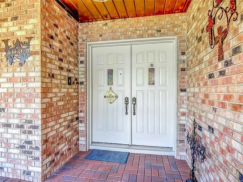 Double door front entry inside covered front porch
