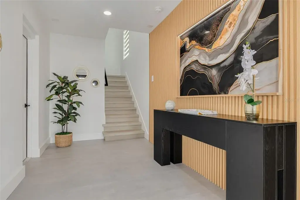 Entry way on the ground floor with the garage entrance on the door to the left.