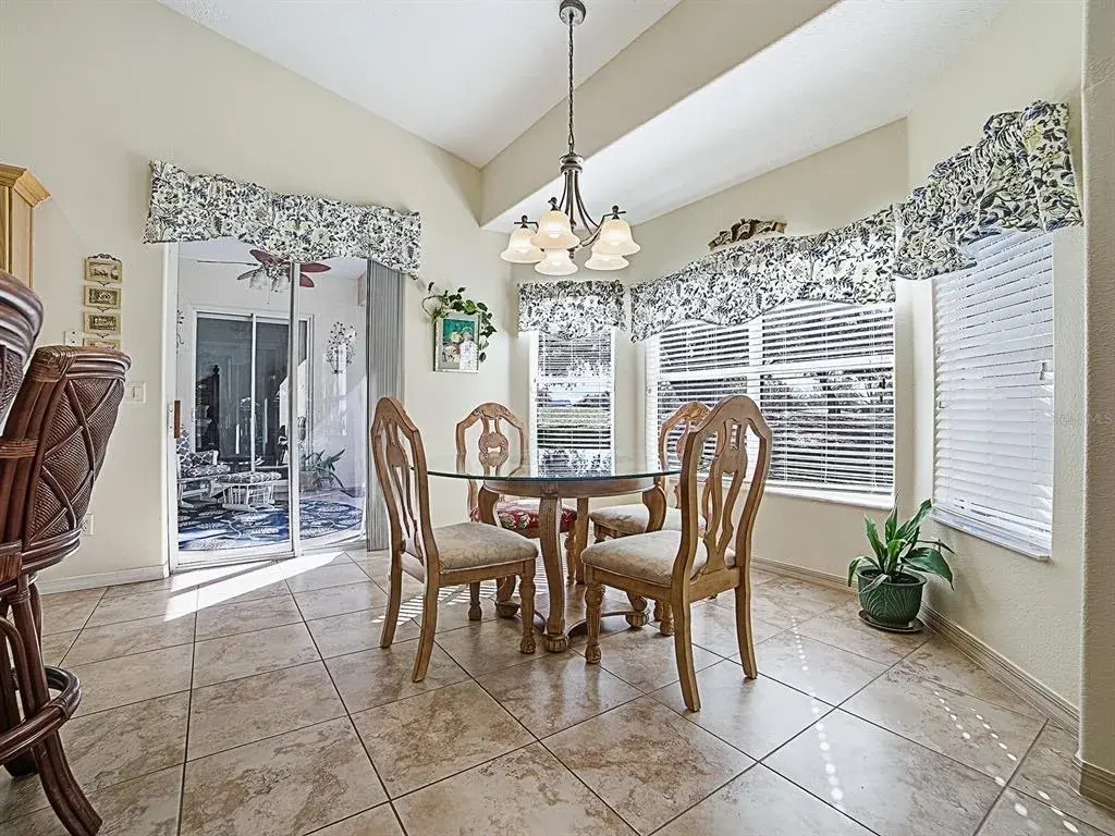 Kitchen Dining has views of Golf Course and Sliders to Screened Lanai.