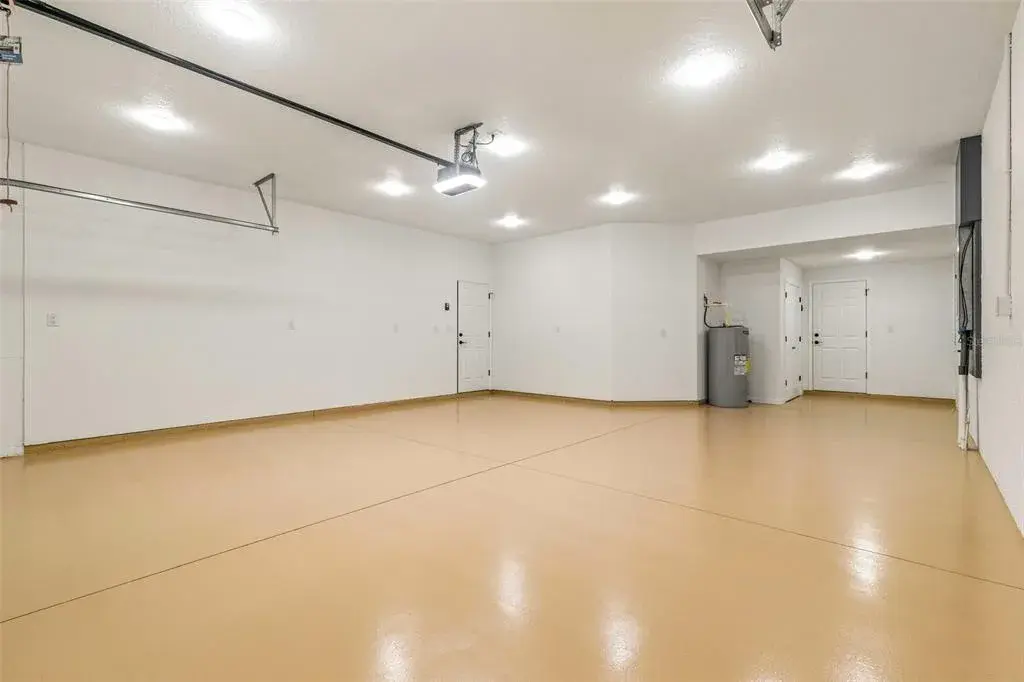 Oversized 2 car garage with tandem space and epoxied floors.