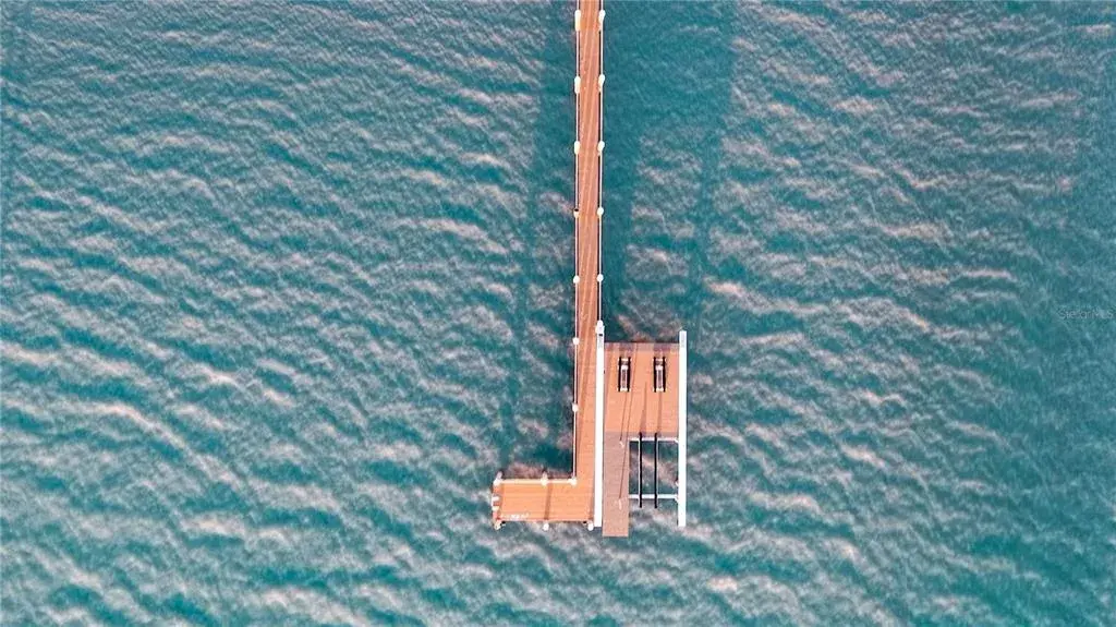 Private dock with lift, watercraft access, and direct Gulf entry.