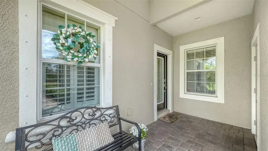 Charming covered front porch and decorative impact-rated front door