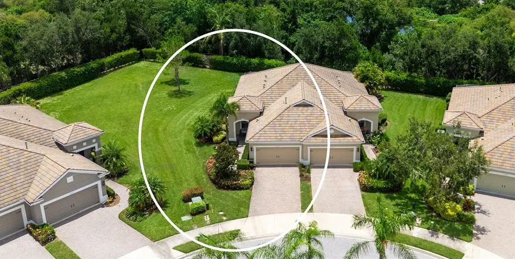 Professionally maintained landscaping, an oversized homesite, stone paver driveway, and an inviting covered entry