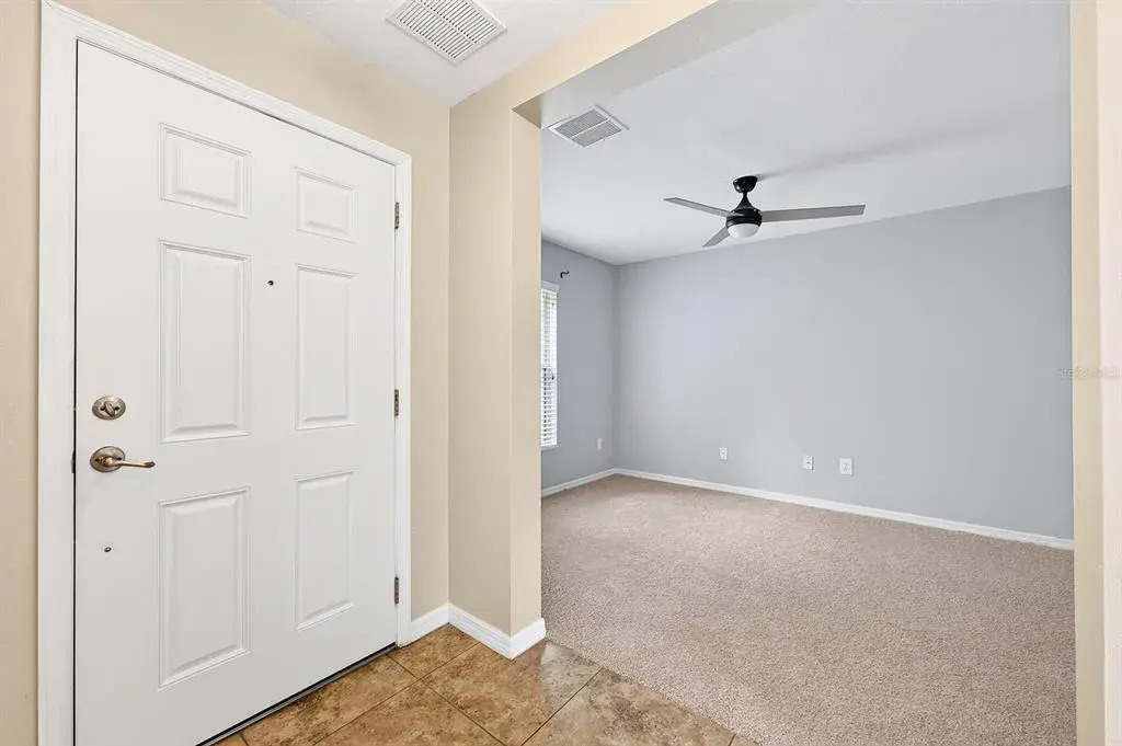 Foyer opens to a versatile formal or flex space.