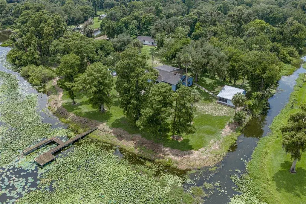 Aerial view of 3 homes, canal and lakefront