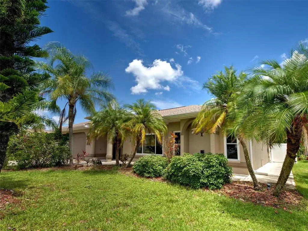 Stunning Florida style home on a lot with mature landscaping.