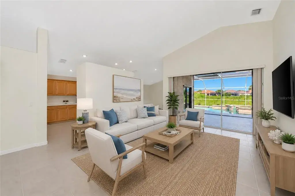 Virtual Staged. Living room view to pool & spa.