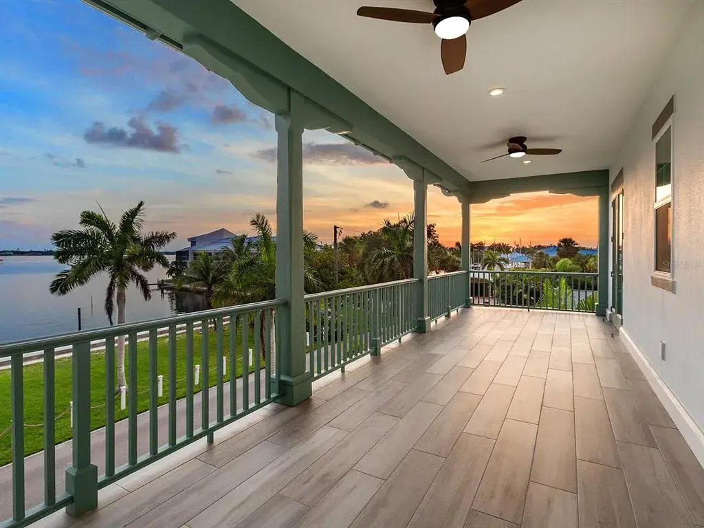 Second-floor primary suite balcony offering Manatee River sunset views