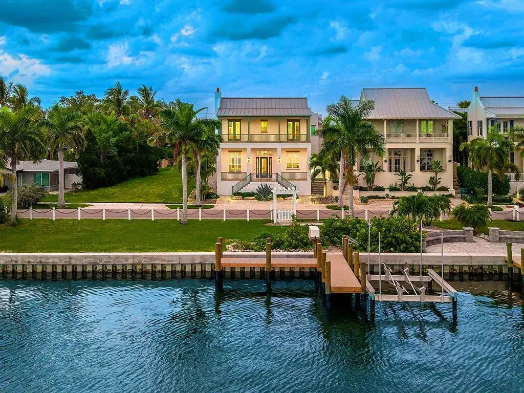 Take advantage of the largest lot in Redfish Cove with 3 bedrooms, 3.5 baths, a caged and heated saltwater pool, in-law suite, oversized garage, and deeded dock with a covered boat lift beside a 2026 seawall