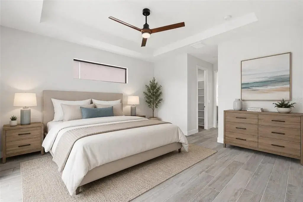 Virtually Staged Spacious Primary Bedroom with Tray Ceiling & Clerestory Window