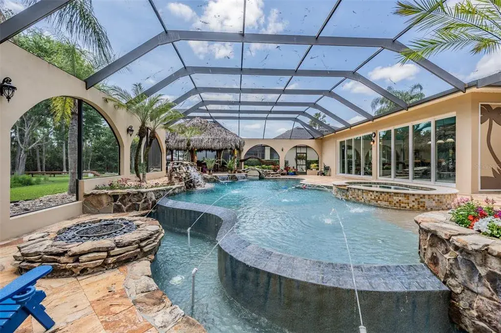 Private Pool Oasis with it's own fountains, waterfalls, spa, Tiki Hut and beach entry pool