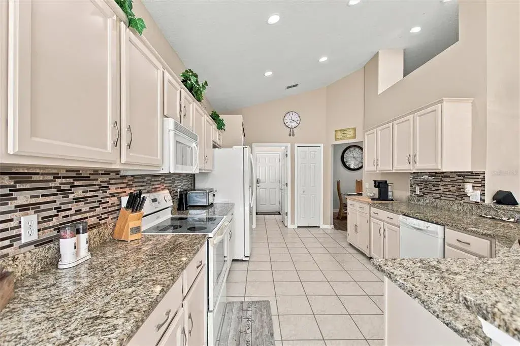 Granite countertops, tile backsplash and recessed  LED lights