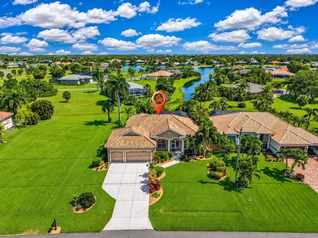 Beautifully positioned beside an expansive greenbelt, this home enjoys a picturesque long view across tropical landscaping toward the winding waterways of Burnt Store Lakes