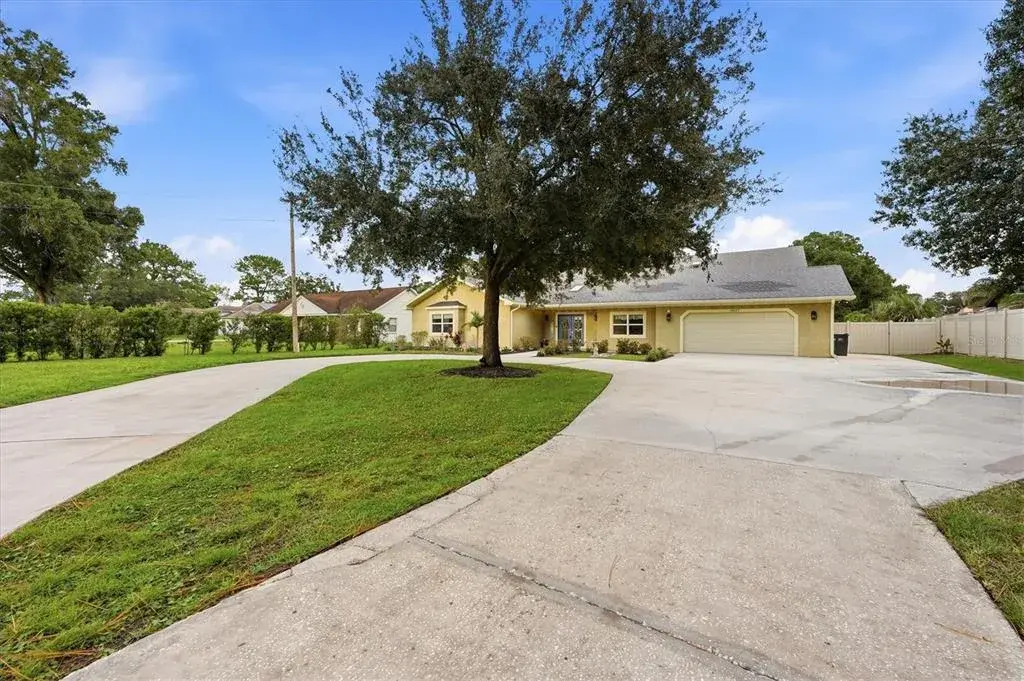 Oversized driveway offers a large parking pad to the right for storing an RV, boat or larger vehicle without blocking the garage.