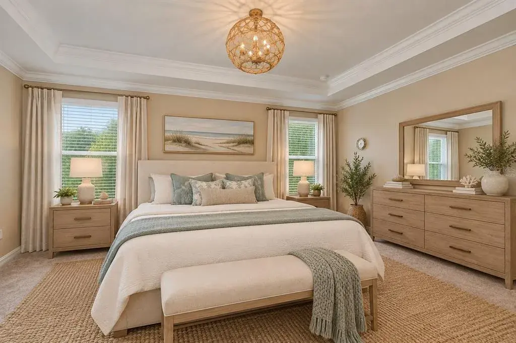 Virtually Staged Luxurious Primary Suite with Tray Ceiling, Crown Molding & Designer Lighting.