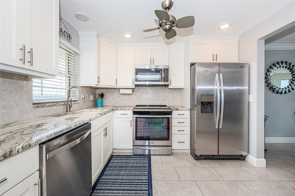 Completely updated kitchen with granite counters, stainless appliances, new lighting and much more