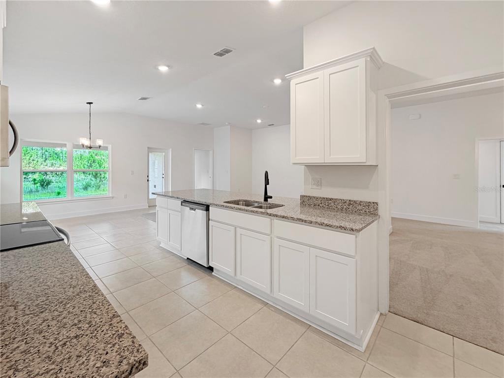 White Cabinets and Granites counter Tops with Black fixtures