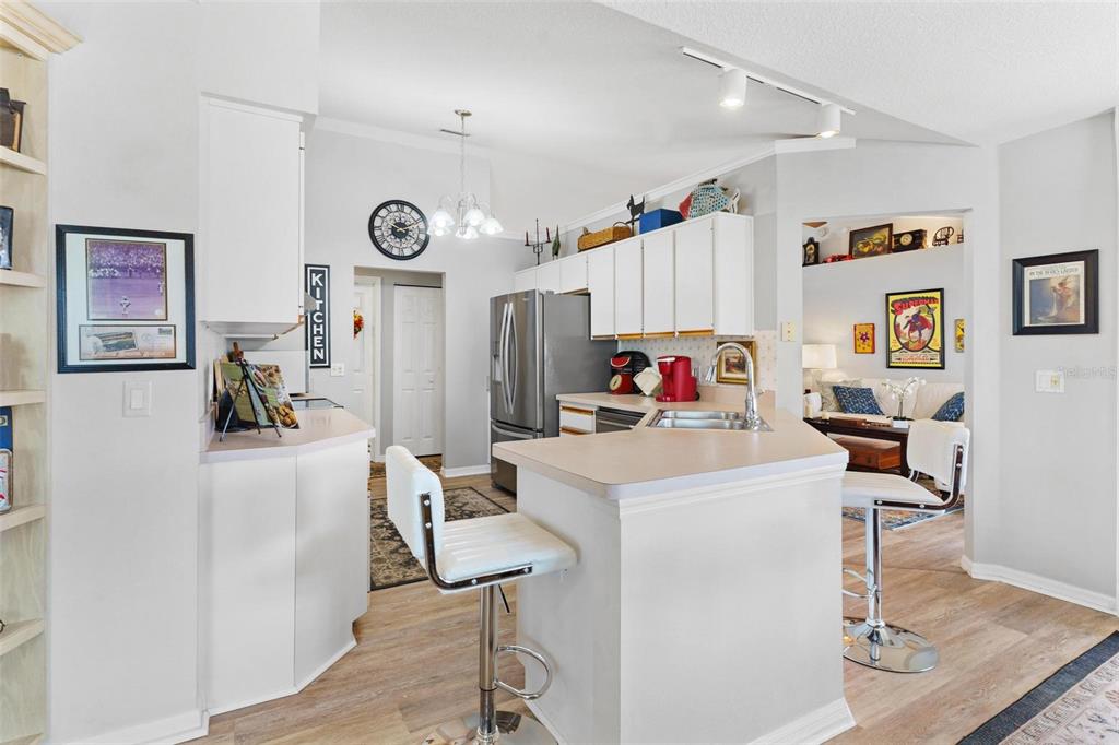 Kitchen features stainless steel appliances while overlooking the family room and kitchen nook/dining area.
