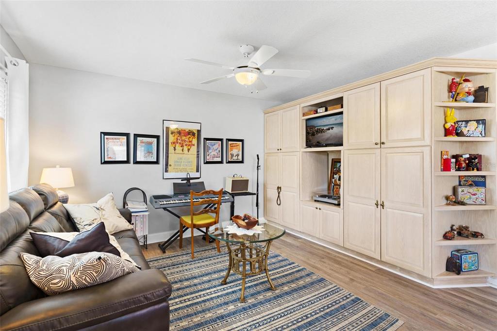 Family Room with Built in entertainment center and overlooks kitchen, kitchen nook/dining area, and Florida Room