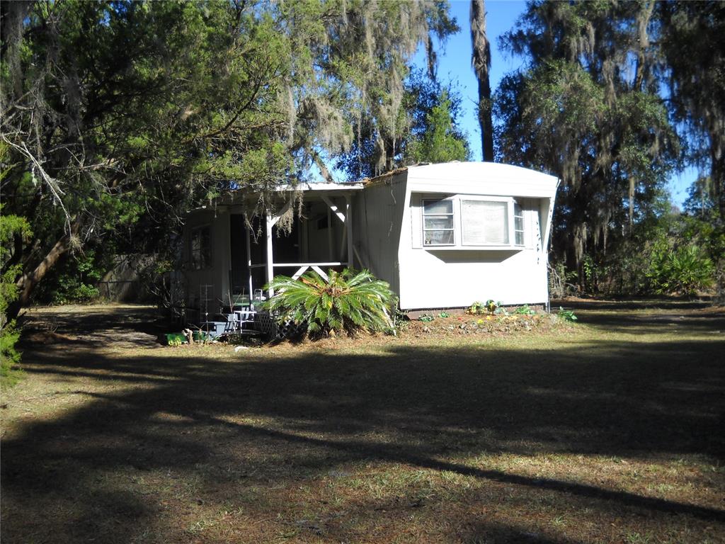 End S/W with added on addition.  Shed with hookups in rear.