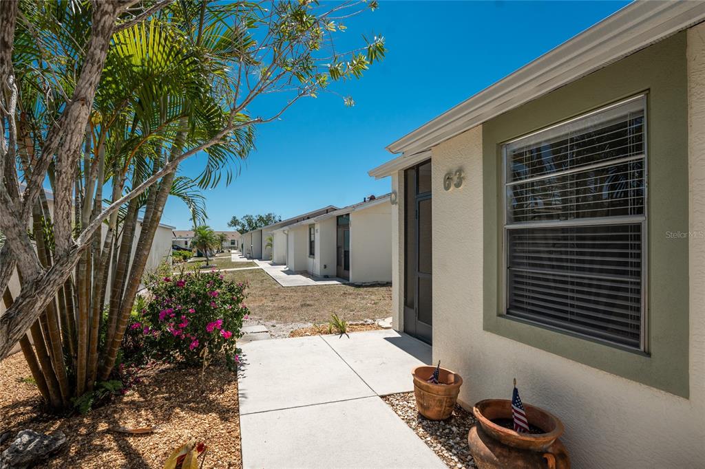 There's a pretty, landscaped walkway up to the front door of this updated 2 BEDROOM/ 2 BATH condo in Village of Wildflower!