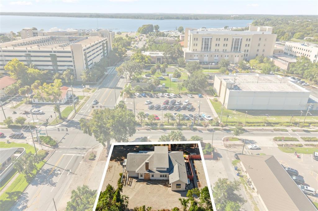 Downtown Tavares, office building front center, courthouse, parking garage and Lake Dora in view