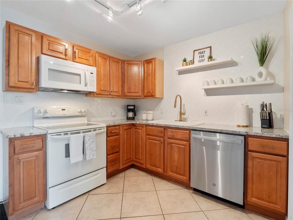 Well appointed kitchen featuring ample cabinetry and generous counter space