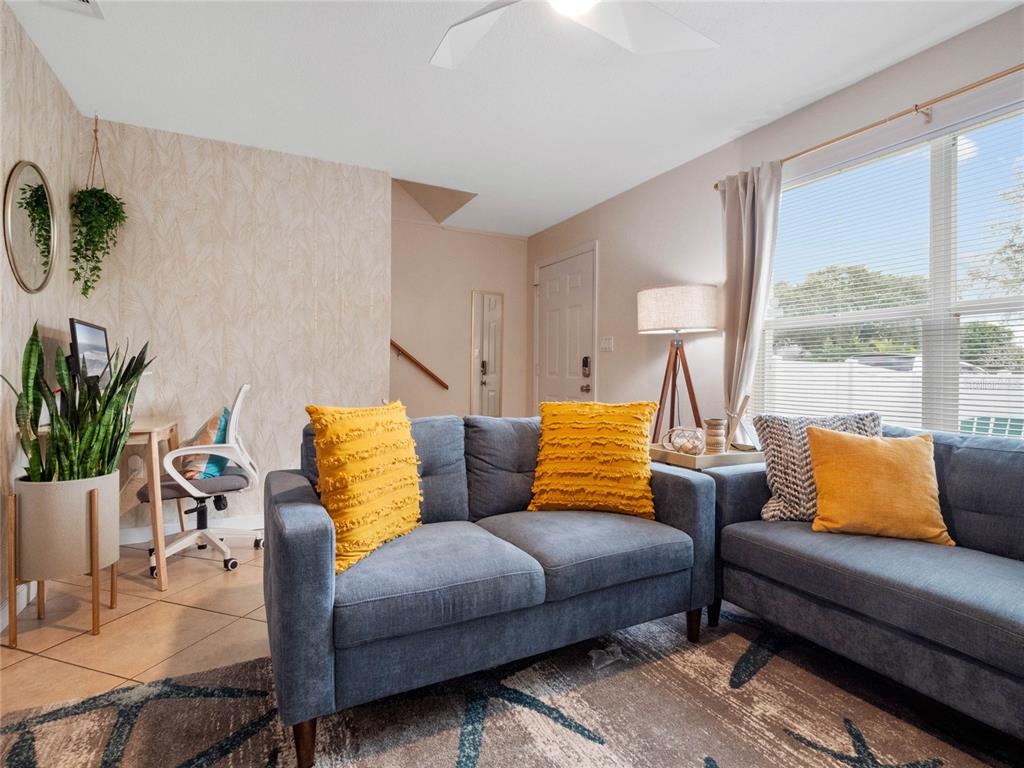 Bright and inviting living room with comfortable seating and abundant natural light.