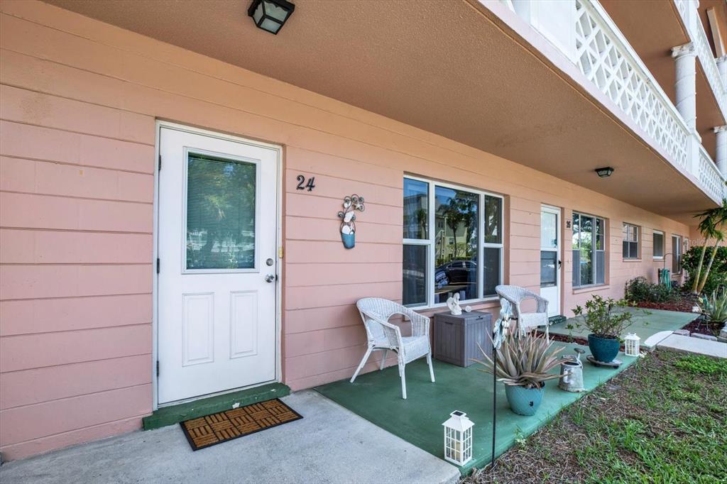 Ground-floor unit with covered front patio and seating space