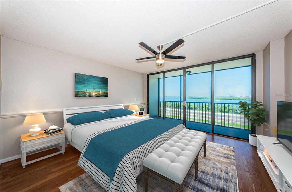 Virtually staged primary bedroom with balcony and floor to ceiling sliders