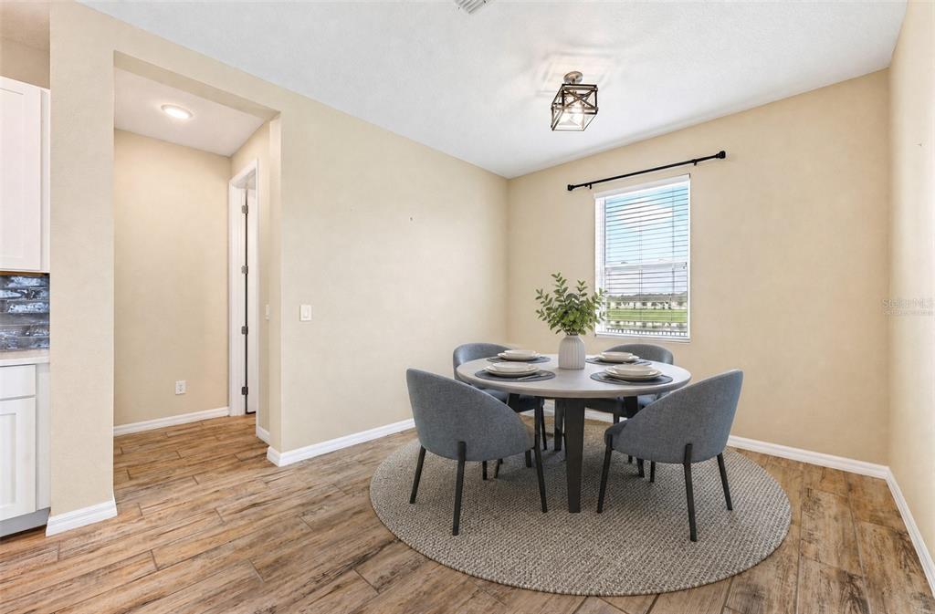 **Virtually Staged** Cozy breakfast nook with an updated light fixture