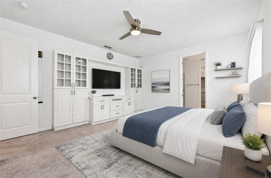 **Virtually Staged** Stunning primary suite with built-ins, carpet, and a ceiling fan