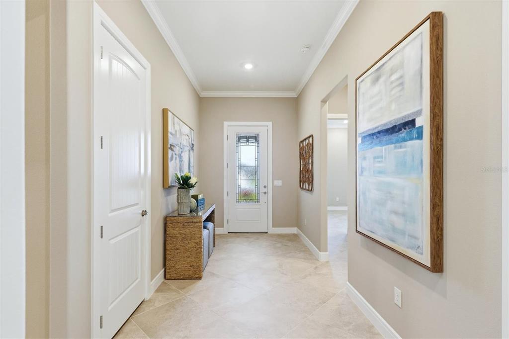 A "Coat" closet. %-1/4 baseboards, 11 ft ceilings and crown molding provide an impressive welcome