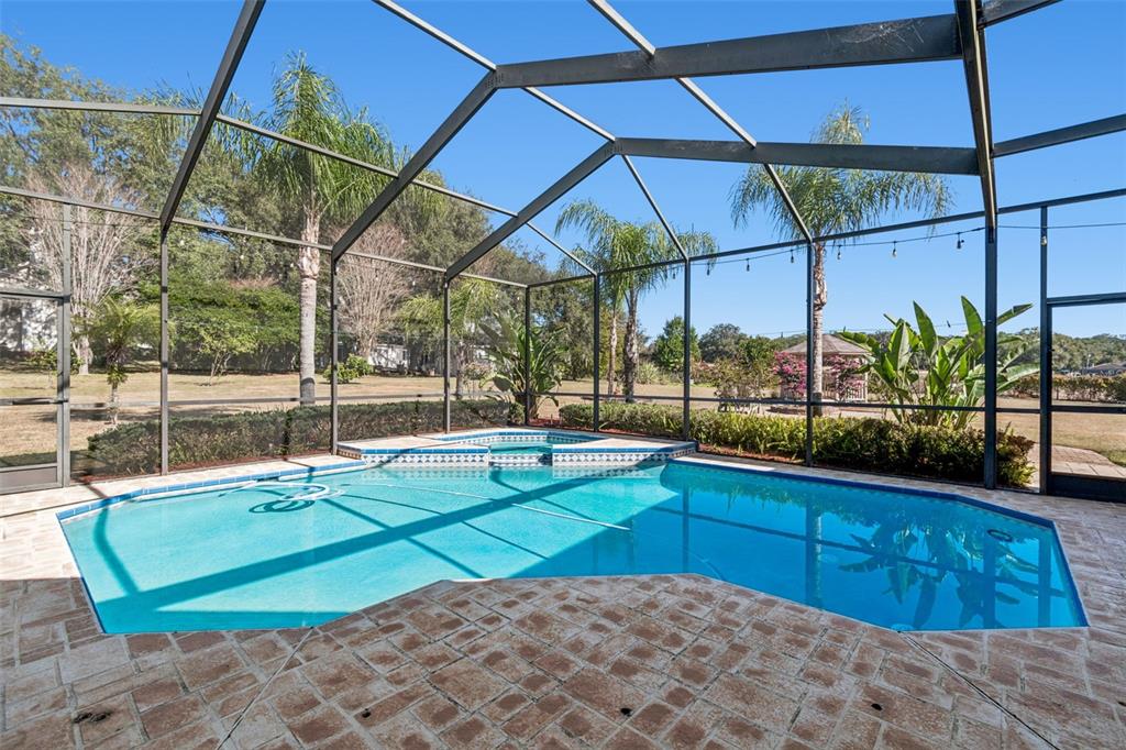 Private tropical oasis with mature landscaping and no rear neighbors.