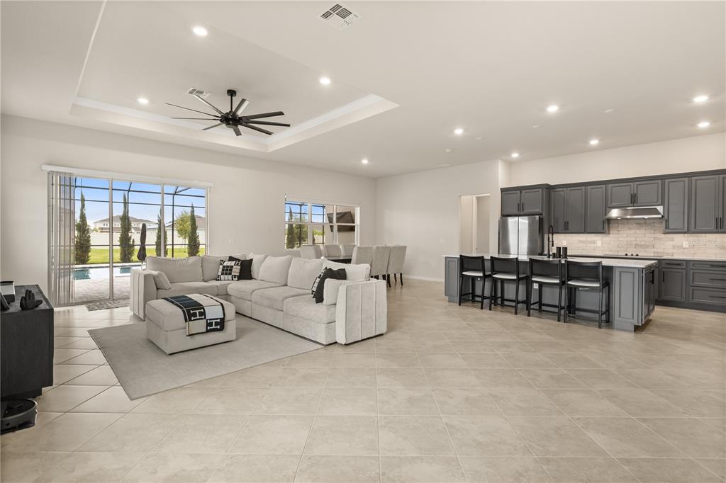 Oversized living area with dining room/ kitchen combo with pool views