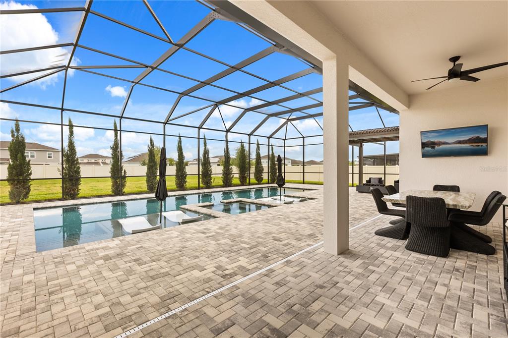 Oversized covered patio with screened in pool and gazebo area
