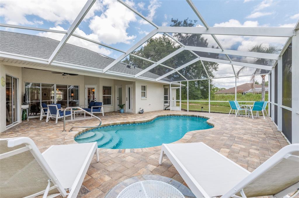 Screened-in Pool with pavers and lanai