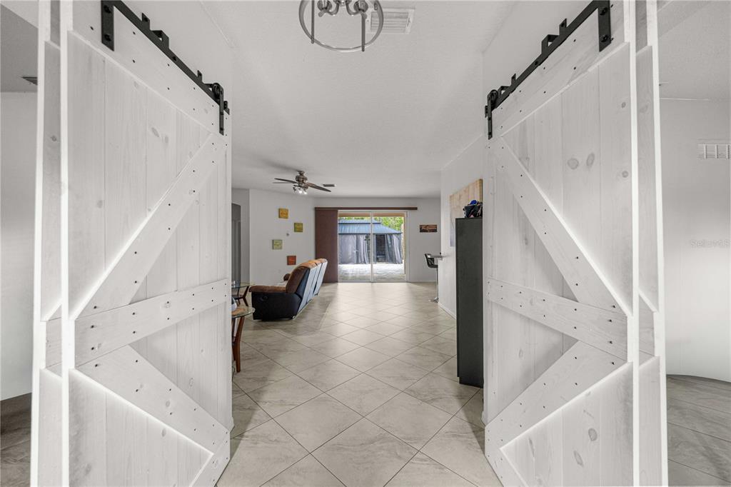 Entry area with barn doors to flex space